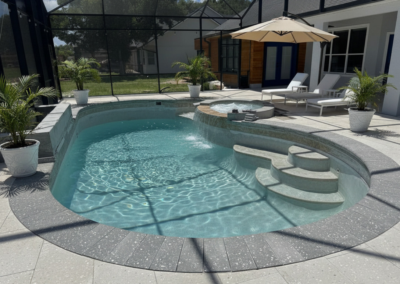pool deck with shell pavers and shell coping